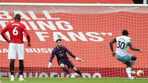MANCHESTER, ENGLAND - JULY 22: Michail Antonio of West Ham United scores his team's first goal from a penalty during the Premier League match between Manchester United and West Ham United at Old Trafford on July 22, 2020 in Manchester, England. Football Stadiums around Europe remain empty due to the Coronavirus Pandemic as Government social distancing laws prohibit fans inside venues resulting in all fixtures being played behind closed doors. (Photo by Martin Rickett/Pool via Getty Images)