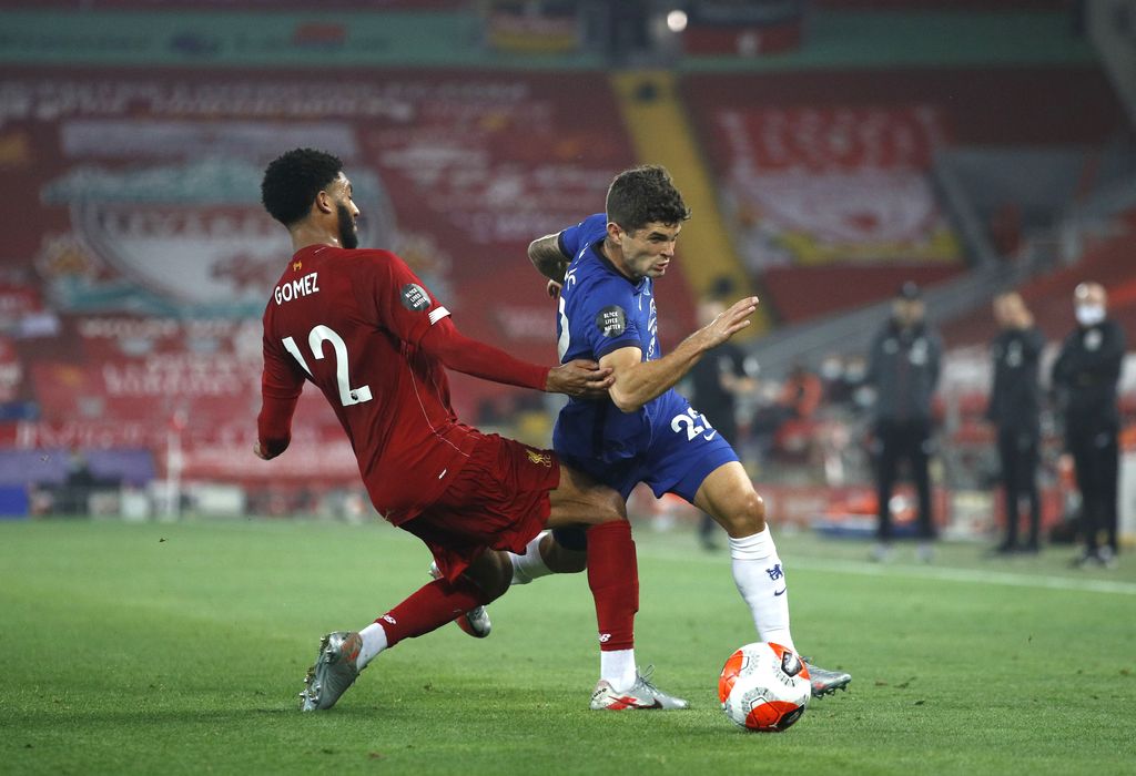 LIVERPOOL, ENGLAND - JULY 22: Joe Gomez of Liverpool and Christian Pulisic of Chelsea battle for the ball during the Premier League match between Liverpool FC and Chelsea FC at Anfield on July 22, 2020 in Liverpool, England. Football Stadiums around Europe remain empty due to the Coronavirus Pandemic as Government social distancing laws prohibit fans inside venues resulting in all fixtures being played behind closed doors. (Photo by Phil Noble/Pool via Getty Images)