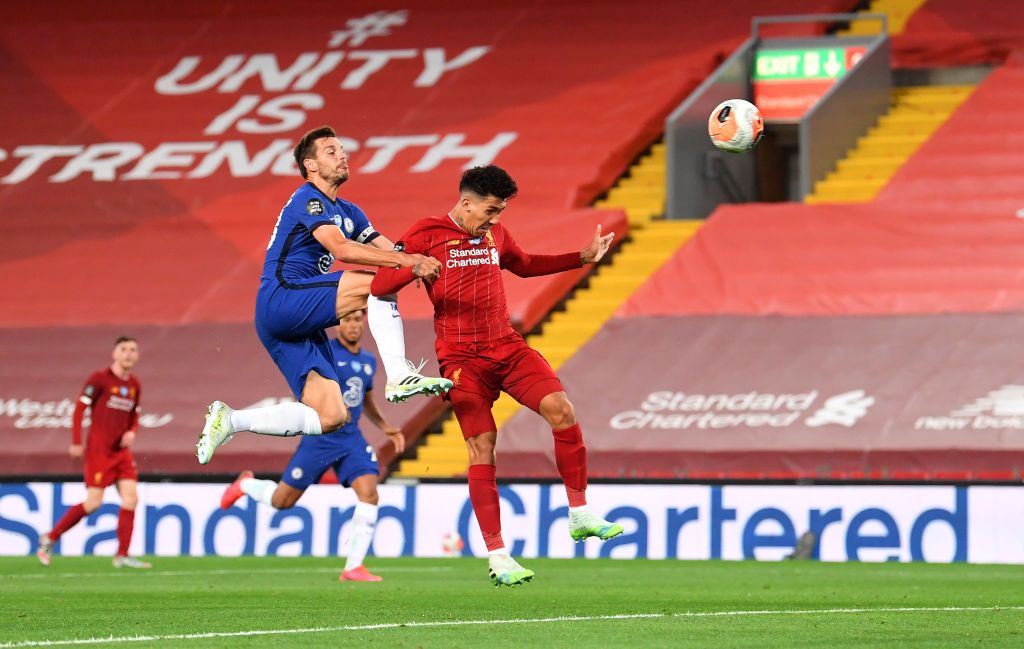 LIVERPOOL, ENGLAND - JULY 22: Roberto Firmino of Liverpool scores his team's fourth goal from a header during the Premier League match between Liverpool FC and Chelsea FC at Anfield on July 22, 2020 in Liverpool, England. Football Stadiums around Europe remain empty due to the Coronavirus Pandemic as Government social distancing laws prohibit fans inside venues resulting in all fixtures being played behind closed doors. (Photo by Laurence Griffiths/Getty Images)