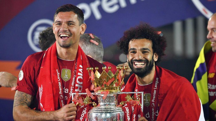 Liverpools Dejan Lovren and Liverpools Mohamed Salah celebrate with the English Premier League trophy aloft after it was presented following the Premier League soccer match between Liverpool and Chelsea at Anfield stadium in Liverpool, England, Wednesday, July 22, 2020. (Paul Ellis, Pool via AP)