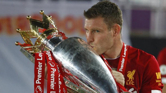 Liverpools James Milner kisses the English Premier League trophy after its presentation following the during the English Premier League soccer match between Liverpool and Chelsea at Anfield Stadium in Liverpool, England, Wednesday, July 22, 2020. Liverpool won the game 5-3. (Phil Noble/Pool via AP)