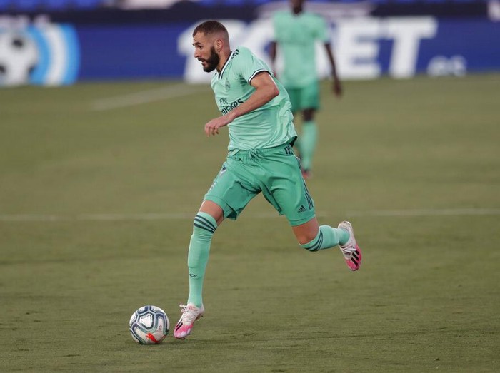 Real Madrid's Karim Benzema runs with the ball during the Spanish La Liga soccer match between Leganes and Real Madrid at the Butarque Stadium in Leganes, on the outskirts of Madrid, Spain, Sunday, July 19, 2020. (AP Photo/Bernat Armangue)