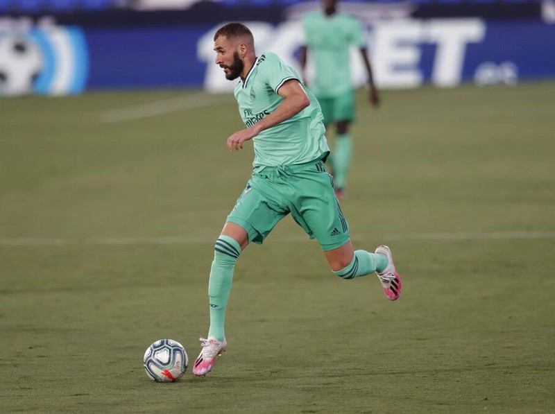 Real Madrid's Karim Benzema runs with the ball during the Spanish La Liga soccer match between Leganes and Real Madrid at the Butarque Stadium in Leganes, on the outskirts of Madrid, Spain, Sunday, July 19, 2020. (AP Photo/Bernat Armangue)