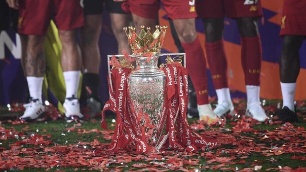The English Premier League trophy is placed on the pitch after it was presented to Liverpool following the Premier League soccer match between Liverpool and Chelsea at Anfield stadium in Liverpool, England, Wednesday, July 22, 2020. (Paul Ellis, Pool via AP)