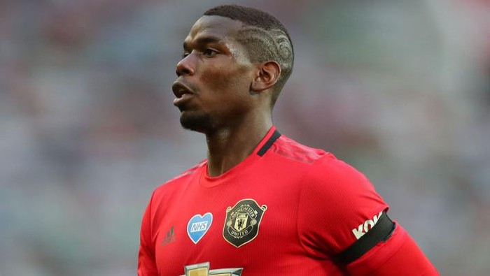 MANCHESTER, ENGLAND - JULY 22: Paul Pogba of Manchester United in action during the Premier League match between Manchester United and West Ham United at Old Trafford on July 22, 2020 in Manchester, England. Football Stadiums around Europe remain empty due to the Coronavirus Pandemic as Government social distancing laws prohibit fans inside venues resulting in all fixtures being played behind closed doors. (Photo by Catherine Ivill/Getty Images)