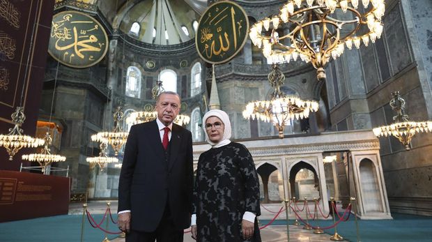 Turkey's President Recep Tayyip Erdogan, accompanied by his wife Emine, poses for photographs as he visits the Byzantine-era Hagia Sophia, in the historic Sultanahmet district of Istanbul, Thursday, July 23, 2020, a day before the first Muslim prayers in the monument in 86 years following its conversion back into a mosque. The conversion of the edifice, once the most important church of Christendom and the 