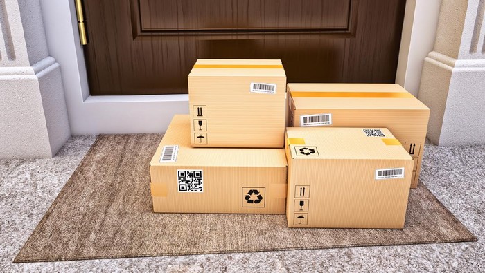 Cardboard boxes on the door mat near the entrance door