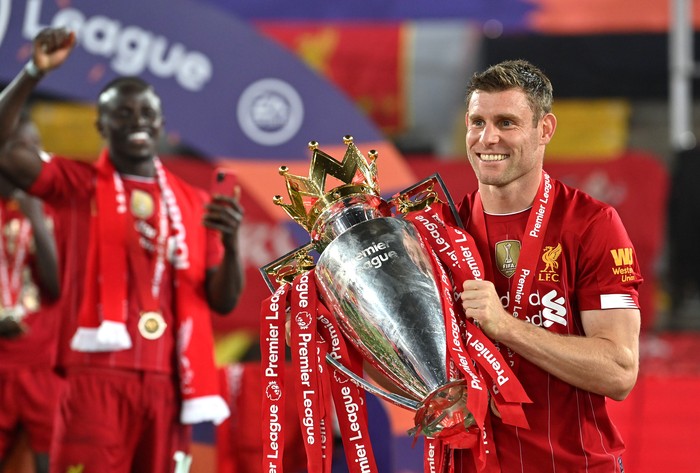James Milner Liverpool LIVERPOOL, ENGLAND - JULY 22: James Milner of Liverpool poses for a photo with The Premier League trophy following the Premier League match between Liverpool FC and Chelsea FC at Anfield on July 22, 2020 in Liverpool, England. Football Stadiums around Europe remain empty due to the Coronavirus Pandemic as Government social distancing laws prohibit fans inside venues resulting in all fixtures being played behind closed doors. (Photo by Paul Ellis/Pool via Getty Images)