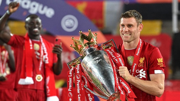 LIVERPOOL, ENGLAND - JULY 22: James Milner of Liverpool poses for a photo with The Premier League trophy following the Premier League match between Liverpool FC and Chelsea FC at Anfield on July 22, 2020 in Liverpool, England. Football Stadiums around Europe remain empty due to the Coronavirus Pandemic as Government social distancing laws prohibit fans inside venues resulting in all fixtures being played behind closed doors. (Photo by Paul Ellis/Pool via Getty Images)