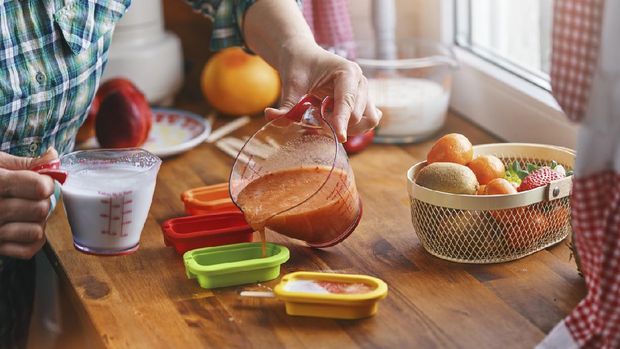 Preparing Fruit Ice Cream on Stick in Domestic Kitchen