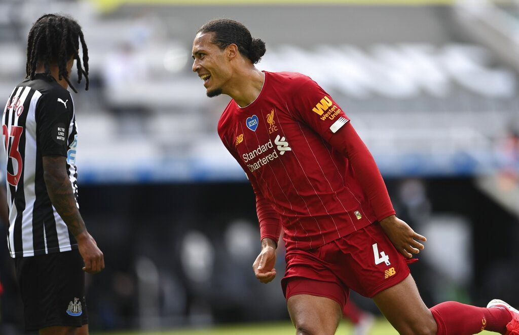 Liverpool's Virgil van Dijk celebrates after scoring his side's first goal during the English Premier League soccer match between Newcastle and Liverpool at St. James' Park in Newcastle, England, Sunday, July 26, 2020. (Laurence Griffiths, Pool via AP)
