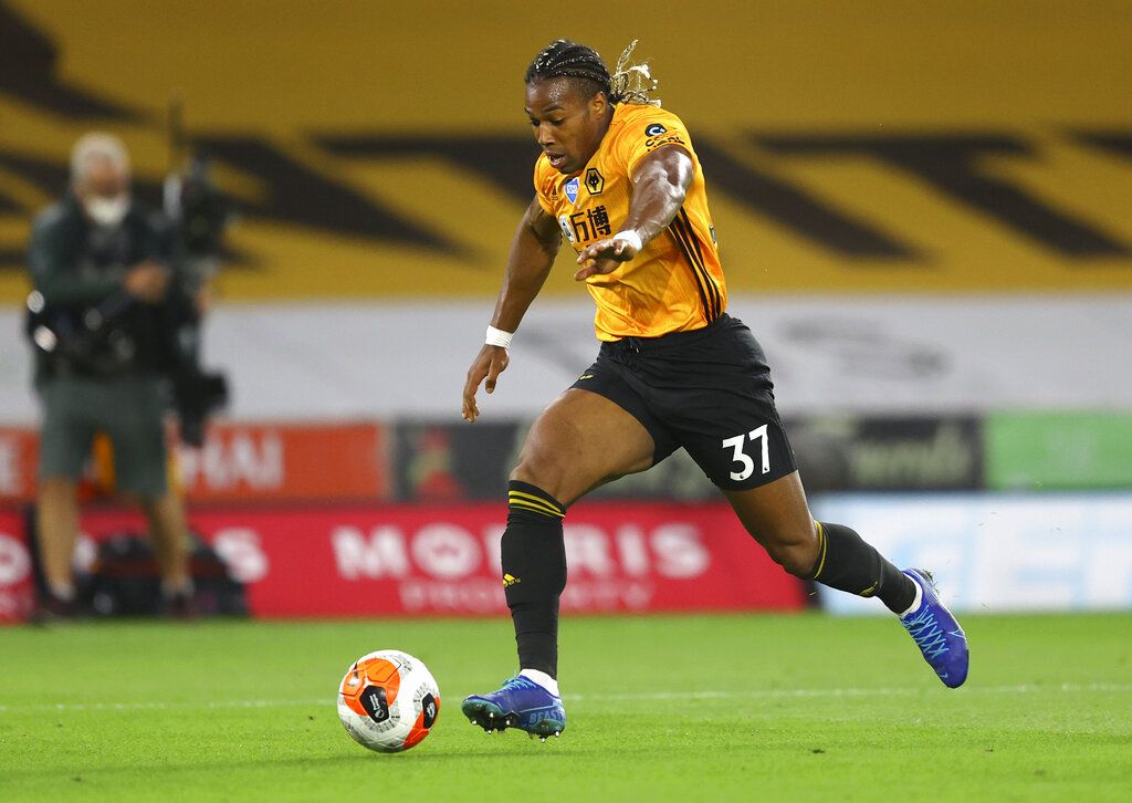 Wolverhampton Wanderers' Adama Traore runs with the ball during the English Premier League soccer match between Wolverhampton Wanderers and Crystal Palace at Molineux Stadium in Wolverhampton, England, Monday, July 20, 2020. (AP Photo/Richard Heathcote,Pool)