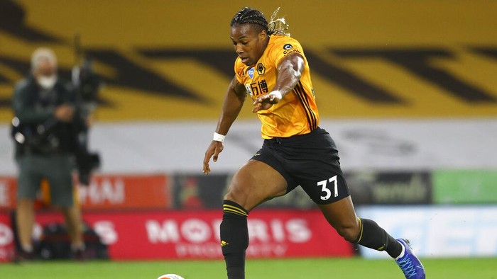 Wolverhampton Wanderers Adama Traore runs with the ball during the English Premier League soccer match between Wolverhampton Wanderers and Crystal Palace at Molineux Stadium in Wolverhampton, England, Monday, July 20, 2020. (AP Photo/Richard Heathcote,Pool)