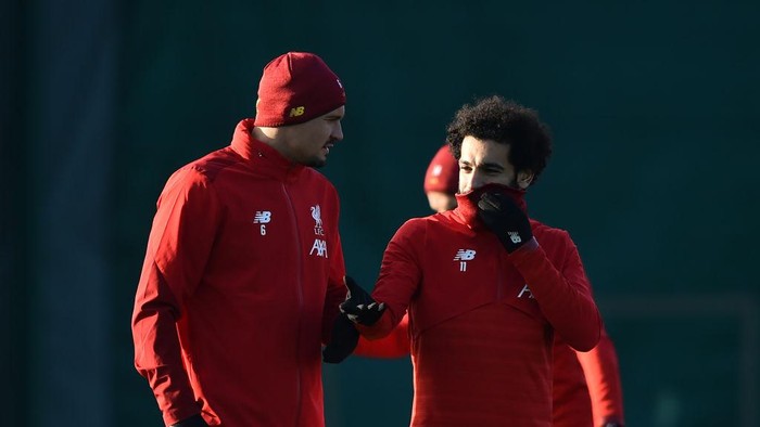 LIVERPOOL, ENGLAND - DECEMBER 09: Mohamed Salah of Liverpool (R) and Dejan Lovren of Liverpool (L) speak during a training session ahead of their UEFA Champions League Group E match against RB Salzburg at Melwood Training Ground on December 09, 2019 in Liverpool, England. (Photo by Nathan Stirk/Getty Images)