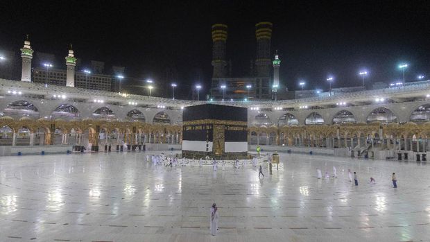 A small number of pilgrims circumambulate the Kaaba, the square structure in the Great Mosque, toward which believers turn when praying, in Mecca, Saudi Arabia, late Sunday, July 26, 2020. Anywhere from 1,000 to 10,000 pilgrims will be allowed to perform the annual hajj pilgrimage this year due to the coronavirus pandemic. (Saudi Ministry of Media via AP)