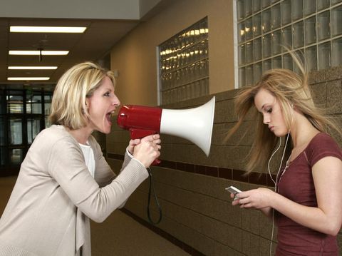 A teenage girl in an argument with her mother and father