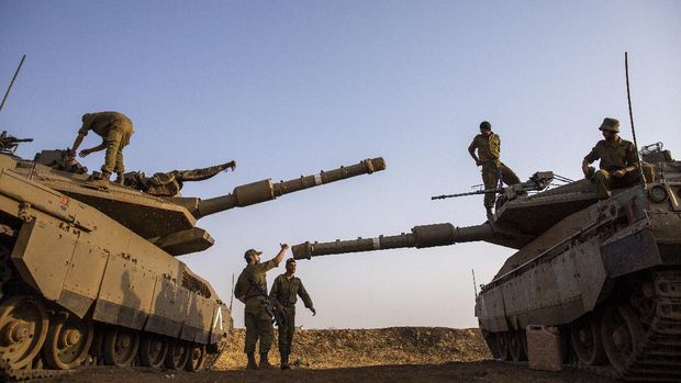 Israeli soldiers work on tanks in the Israeli controlled Golan Heights near the border with Syria, not far from Lebanon border, Tuesday, July 28, 2020. Lebanon's prime minister has accused Israel of provoking a 