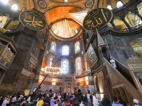 Muslims, wearing protective masks as a precaution against infection from coronavirus gather for the Eid al-Adha prayer inside the Byzantine-era Hagia Sophia, recently converted back to a mosque, in the historic Sultanahmet district of Istanbul, Friday, July 31, 2020. Small groups of pilgrims performed one of the final rites of the Islamic hajj on Friday as Muslims worldwide marked the start of the Eid al-Adha holiday amid a global pandemic that has impacted nearly every aspect of this year’s pilgrimage and celebrations. The last days of hajj coincide with the four-day Eid al-Adha, or “Feast of Sacrifice,” in which Muslims slaughter livestock and distribute the meat to the poor.  (Pool via AP)