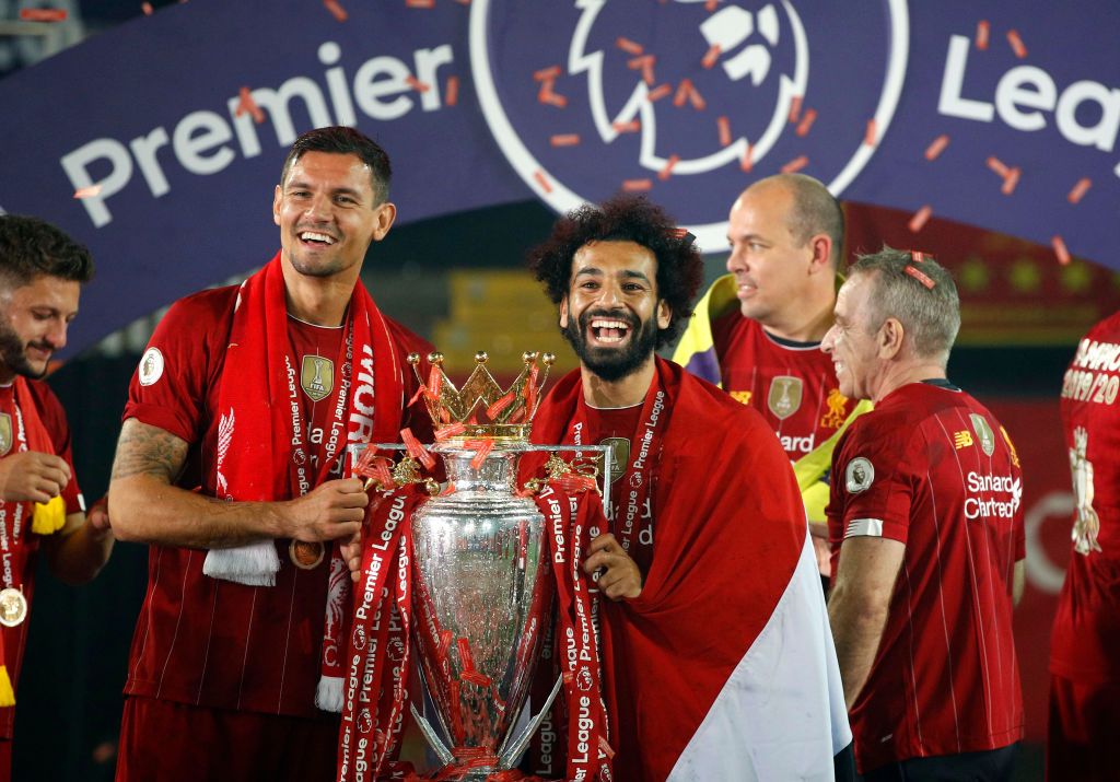 LIVERPOOL, ENGLAND - JULY 22: Liverpool's Dejan Lovren and Mohamed Salah celebrate with the Premier League trophy after the Premier League match between Liverpool FC and Chelsea FC at Anfield on July 22, 2020 in Liverpool, England.  Europe's soccer stadiums remain empty due to the coronavirus pandemic, as government social distancing laws prohibit fans within venues, causing all matches to be played behind closed doors.  (Photo by Phil Noble / Pool via Getty Images)