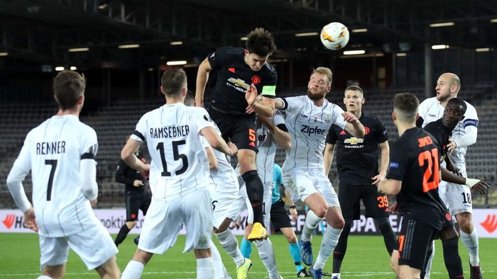 LINZ, AUSTRIA - MARCH 12: (FREE FOR EDITORIAL USE) In this handout image provided by UEFA, Harry Maguire of Manchester United wins a header during the UEFA Europa League round of 16 first leg match between LASK and Manchester United at Linzer Stadion on March 12, 2020 in Linz, Austria. The match is played behind closed doors as a precaution against the spread of COVID-19 (Coronavirus).  (Photo by UEFA - Handout/UEFA via Getty Images )