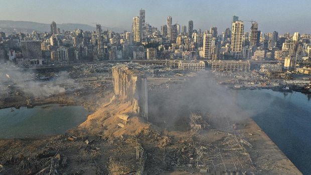 A drone picture shows the scene of an explosion at the seaport of Beirut, Lebanon, Wednesday, Aug. 5, 2020. A massive explosion rocked Beirut on Tuesday, flattening much of the city's port, damaging buildings across the capital and sending a giant mushroom cloud into the sky. More than 70 people were killed and 3,000 injured, with bodies buried in the rubble, officials said. (AP Photo/Hussein Malla)