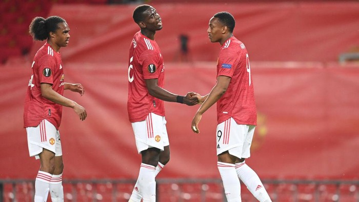 MANCHESTER, ENGLAND - AUGUST 05: Anthony Martial of Manchester United celebrates after scoring his sides second goal with Paul Pogba during the UEFA Europa League round of 16 second leg match between Manchester United and LASK at Old Trafford on August 05, 2020 in Manchester, England. (Photo by Michael Regan/Getty Images)