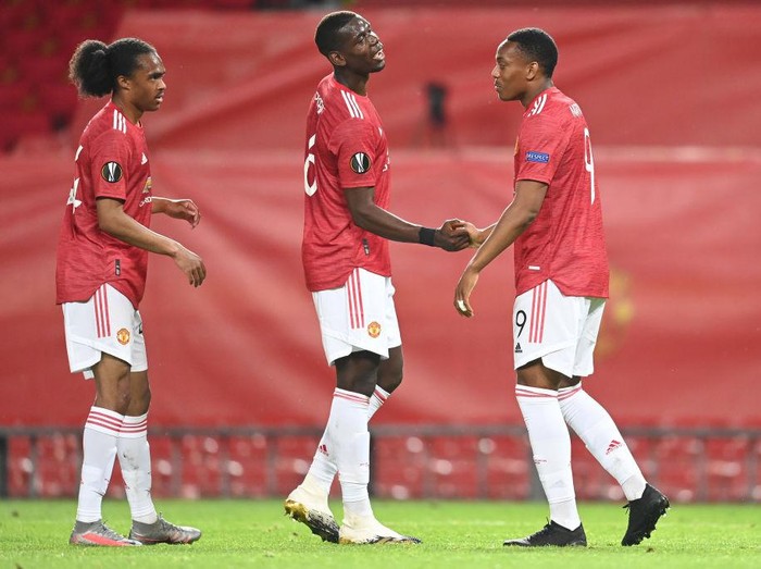 MANCHESTER, ENGLAND - AUGUST 05: Anthony Martial of Manchester United celebrates after scoring his sides second goal with Paul Pogba during the UEFA Europa League round of 16 second leg match between Manchester United and LASK at Old Trafford on August 05, 2020 in Manchester, England. (Photo by Michael Regan/Getty Images)