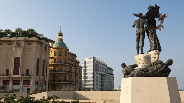 Beirut, Lebanon - August 27, 2010: A view from Martyrs Square. On the right is the landmark Martyrs Statue. On the left is a Virgin Megastore and Dunkin Donuts.