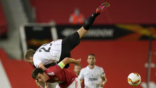 LASK's Marko Raguz is airborne as he battles for the ball with Manchester United's Harry Maguire during the Europa League round of 16 second leg soccer match between Manchester United and LASK at Old Trafford in Manchester, England, Wednesday, Aug. 5, 2020. (AP Photo/Dave Thompson)