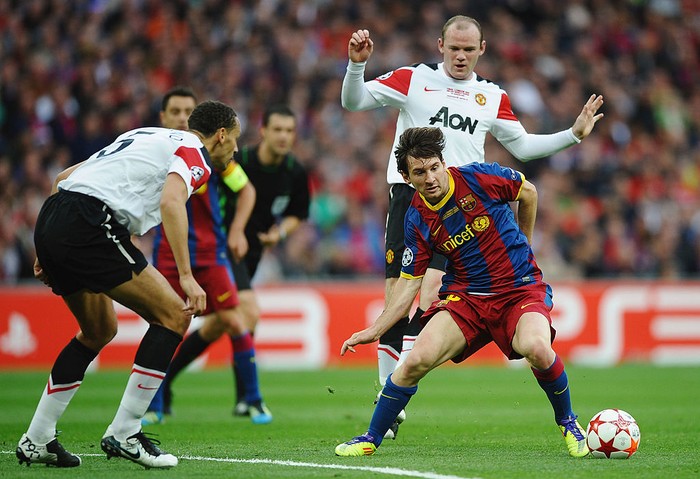 LONDON, ENGLAND - MAY 28:  Lionel Messi of FC Barcelona (R) in action against Rio Ferdinand (L) and Wayne Rooney (back) of Manchester United during the UEFA Champions League final between FC Barcelona and Manchester United FC at Wembley Stadium on Ma