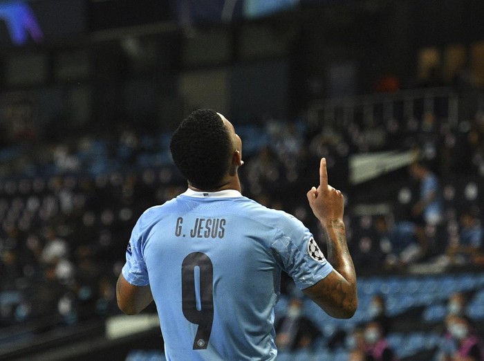 Manchester Citys Gabriel Jesus celebrates after scoring his sides second goal during the Champions League, round of 16, second leg soccer match between Manchester City and Real Madrid at the Etihad Stadium in Manchester, England, Friday, Aug. 7, 2020. (Oli Scarff/Pool Photo via AP)