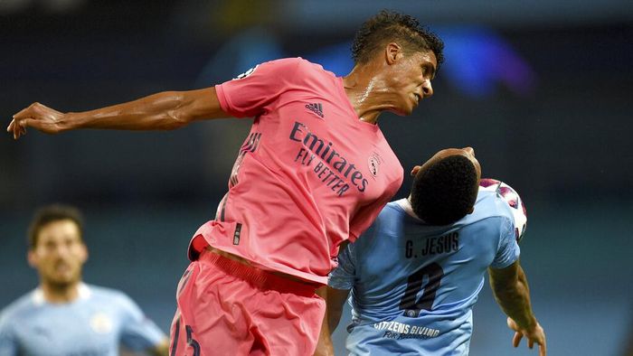 Raphael Varane Real Madrids Raphael Varane jumps for a header with Manchester Citys Gabriel Jesus during the Champions League, round of 16, second leg soccer match between Manchester City and Real Madrid at the Etihad Stadium in Manchester, England, Friday, Aug. 7, 2020. (Oli Scarff/Pool Photo via AP)