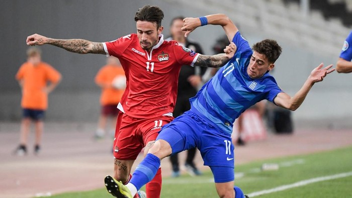 Liechtensteins forward Dennis Salanovic (L) fights for the ball with Greeces Kostas Tsimikas during the Euro 2020 group J qualifying football match Greece against Liechtenstein at the Athens Olympic stadium on September 8, 2019. (Photo by ARIS MESSINIS / AFP)