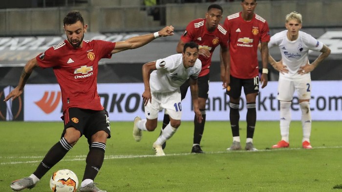 Manchester Uniteds Bruno Fernandes scores his sides first goal from a penalty kick during the UEFA Europa League quarterfinal soccer match between Manchester United and FC Copenhagen in Cologne, Germany, Monday, Aug. 10, 2020. (Wolfgang Rattay/Pool via AP)