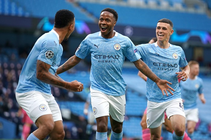 MANCHESTER, ENGLAND - AUGUST 07: Raheem Sterling of Manchester City celebrates with teammates Gabriel Jesus and Phil Foden after scoring his teams first goal during the UEFA Champions League round of 16 second leg match between Manchester City and Real Madrid at Etihad Stadium on August 07, 2020 in Manchester, England. (Photo by Dave Thompson/Pool via Getty Images)