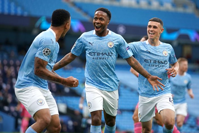 Raheem Sterling MANCHESTER, ENGLAND - AUGUST 07: Raheem Sterling of Manchester City celebrates with teammates Gabriel Jesus and Phil Foden after scoring his teams first goal during the UEFA Champions League round of 16 second leg match between Manchester City and Real Madrid at Etihad Stadium on August 07, 2020 in Manchester, England. (Photo by Dave Thompson/Pool via Getty Images)