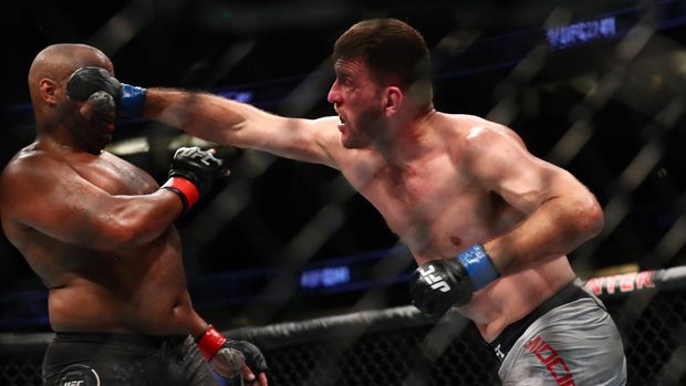 ANAHEIM, CALIFORNIA - AUGUST 17: Stipe Miocic throws a punch at Daniel Cormier in the second round during their UFC Heavyweight Title Bout at UFC 241 at Honda Center on August 17, 2019 in Anaheim, California.   Joe Scarnici/Getty Images/AFP