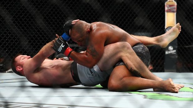 ANAHEIM, CALIFORNIA - AUGUST 17: Stipe Miocic and Daniel Cormier fight from the floor in the first round during their UFC Heavyweight Title Bout at UFC 241 at Honda Center on August 17, 2019 in Anaheim, California.   Joe Scarnici/Getty Images/AFP