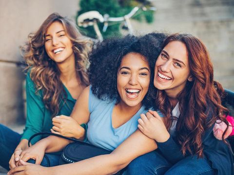 Small multi-ethnic group of beautiful young women laughing outdoors