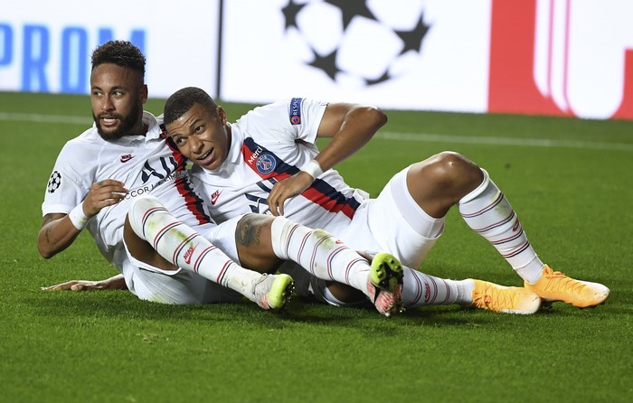 PSGs Neymar, left, celebrates with Kylian Mbappe after teammate Eric Maxim Choupo-Moting scored his teams second goal during the Champions League quarterfinal match between Atalanta and PSG at Luz stadium, Lisbon, Portugal, Wednesday, Aug. 12, 2020. (David Ramos/Pool Photo via AP)