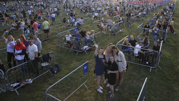 Fans occupy separate pens to force social distancing, ahead of the Sam Fender rock concert at the Virgin Money Unity Arena, a pop-up venue for the gig in Gosforth Park, Newcastle, northern England, Tuesday Aug. 11, 2020.  Fans in groups of up to five people will watch the show from 500 separated zones at what the promoters say is the world's first socially-distanced COVID-19 gig. (Owen Humphreys/PA via AP)