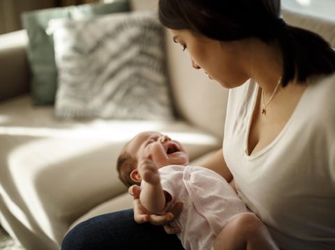 Newborn baby crying in mother hands