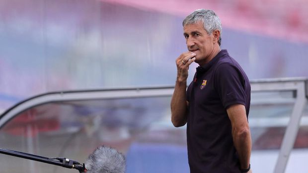 Barcelona's head coach Quique Setien gives an interview on the pitch before a training session at the Luz stadium in Lisbon, Thursday Aug. 13, 2020. Barcelona will play Bayern Munich in a Champions League quarterfinals soccer match on Friday. (AP Photo/Manu Fernandez, Pool)