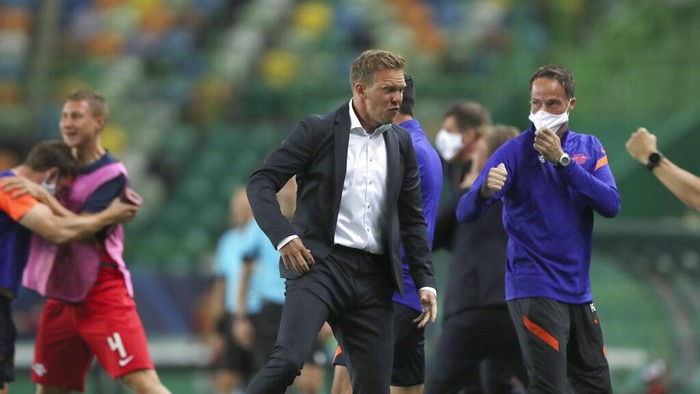 Leipzigs head coach Julian Nagelsmann celebrates his teams second goal during the Champions League quarterfinal match between RB Leipzig and Atletico Madrid at the Jose Alvalade stadium in Lisbon, Portugal, Thursday, Aug. 13, 2020. (Miguel A. Lopes/Pool Photo via AP)