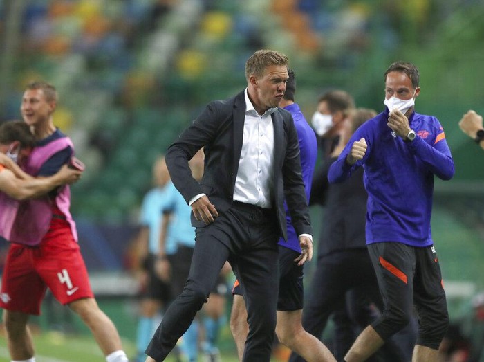 Leipzigs head coach Julian Nagelsmann celebrates his teams second goal during the Champions League quarterfinal match between RB Leipzig and Atletico Madrid at the Jose Alvalade stadium in Lisbon, Portugal, Thursday, Aug. 13, 2020. (Miguel A. Lopes/Pool Photo via AP)