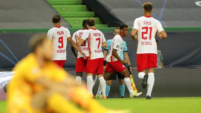 Leipzigs Tyler Adams, right, celebrates after scoring his sides second goal during the Champions League quarterfinal match between RB Leipzig and Atletico Madrid at the Jose Alvalade stadium in Lisbon, Portugal, Thursday, Aug. 13, 2020. (Miguel A. Lopes/Pool Photo via AP)