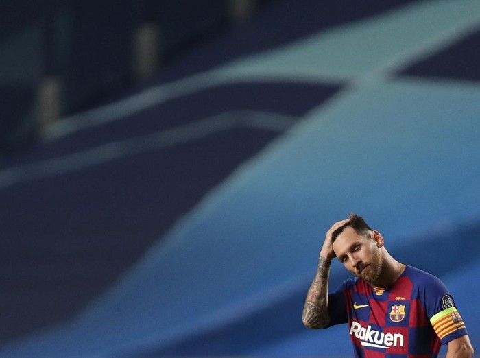 Barcelonas Lionel Messi holds his head during the Champions League quarterfinal match between FC Barcelona and Bayern Munich at the Luz stadium in Lisbon, Portugal, Friday, Aug. 14, 2020. (AP Photo/Manu Fernandez/Pool)