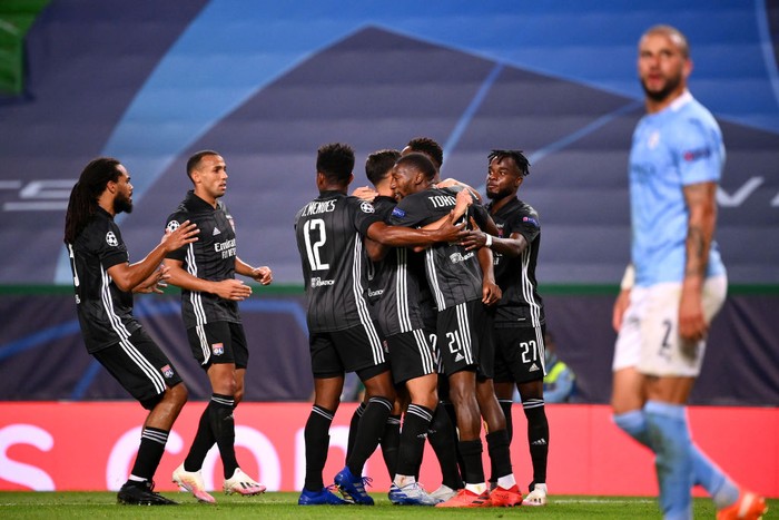 LISBON, PORTUGAL - AUGUST 15: Moussa Dembele of Olympique Lyon celebrates with teammates after scoring his teams third goal during the UEFA Champions League Quarter Final match between Manchester City and Lyon at Estadio Jose Alvalade on August 15, 2020 in Lisbon, Portugal. (Photo by Franck Fife/Pool via Getty Images)