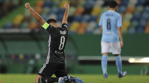 Lyon's Houssem Aouar reacts at the end of the Champions League quarterfinal soccer match between Lyon and Manchester City at the Jose Alvalade stadium in Lisbon, Portugal, Saturday, Aug. 15, 2020. Lyon won the match 3-1. (Miguel A. Lopes/Pool via AP)