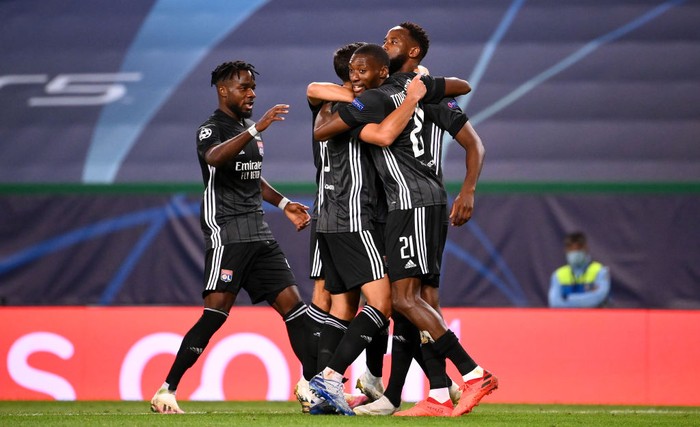 LISBON, PORTUGAL - AUGUST 15: Moussa Dembele of Olympique Lyon celebrates with teammates after scoring his teams third goal during the UEFA Champions League Quarter Final match between Manchester City and Lyon at Estadio Jose Alvalade on August 15, 2020 in Lisbon, Portugal. (Photo by Franck Fife/Pool via Getty Images)